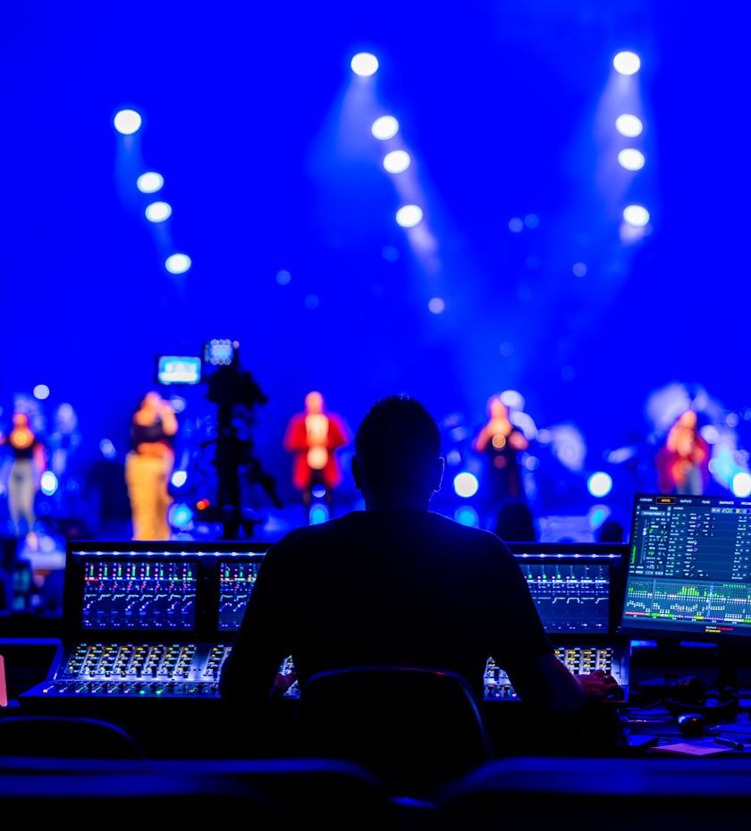 Sound engineer at the mixing console during a live concert